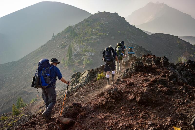 Hiker on mountain peak overlooking stunning Caucasus landscape