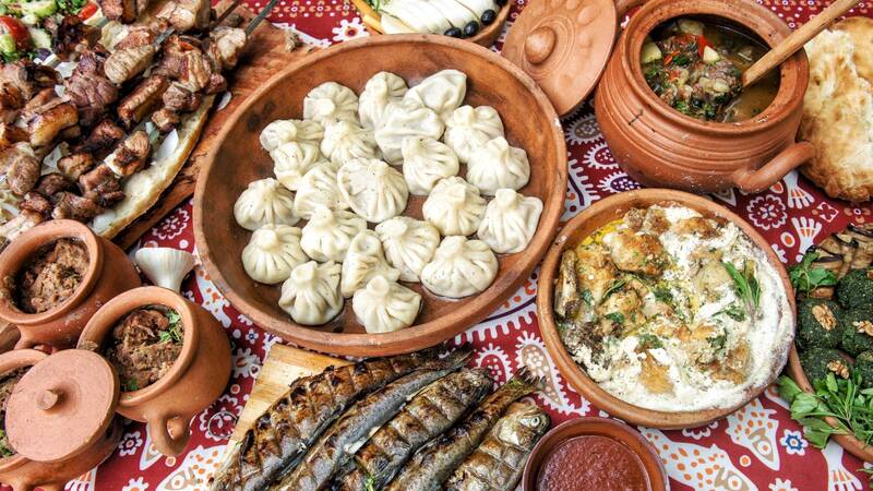 Traditional Georgian supra feast with variety of dishes on table