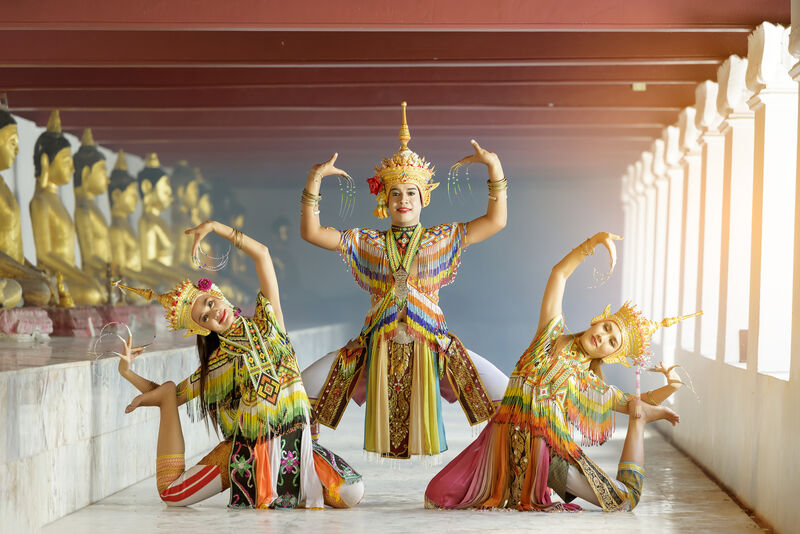 Traditional Thai dance performance with elaborate golden costumes and ornate headdresses