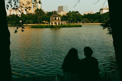 Aerial view of Hanoi with Hoan Kiem Lake and the Red River surrounded by dense urban development